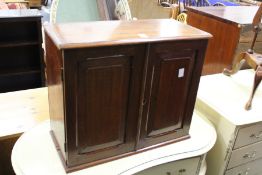 An Edwardian mahogany table top two door cabinet.