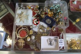 A silver filigree brooch and other jewellery.