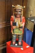 A carved and painted wood figure.