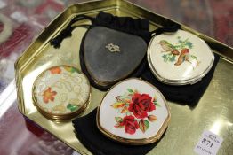 Four decorative ladies' compacts.