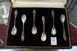 A cased set of six coffee spoons with pierced handles.