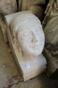 A large reconstituted stone human head corbel.