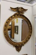 A good large Regency design circular wall mirror with eagle cresting.