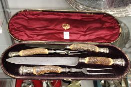 A cased horn handled carving set.