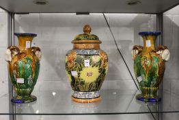 A Majolica style pottery jar and cover and a pair of similar vases.