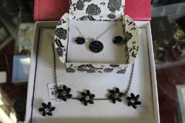 Two necklace and earring sets.