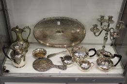 A plated candelabra, a tray and other items.