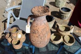A terracotta jug and two small garden urn shaped planters.