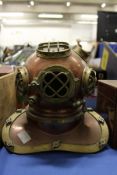 A small copper and brass model of a diver's helmet.