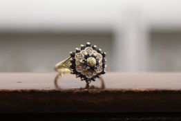 A good gold, diamond and sapphire cluster ring.