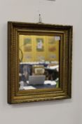 A small gilt framed mirror.