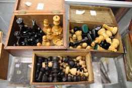 A quantity of chess pieces in three boxes.