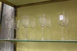 A set of eight cut glass wine glasses.