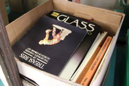 A box of art and antique reference books.