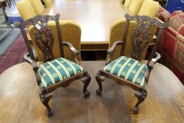 A pair of Chippendale style miniature mahogany armchairs.