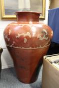A large floor standing terracotta vase with painted decoration.