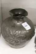 An Art Nouveau pewter vase.