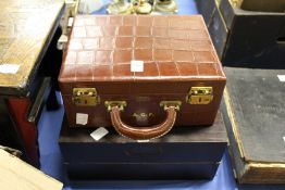 A crocodile style leather vanity case and a wooden games box.