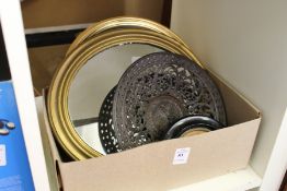 A small mirror, a cast metal dish and other decorative items.