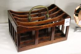 A small mahogany four division stationery rack with brass handles.
