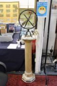 A painted sundial on pedestal base.