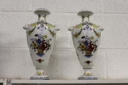 A pair of continental floral decorated porcelain vases.