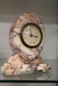 An alabaster cased oval mantle clock.
