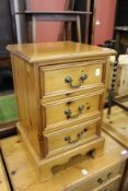 A pine three drawer bedside chest.