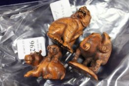 Three carved wood netsukes.