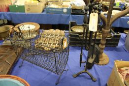 A wrought iron companion set and a magazine rack.