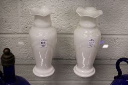 A pair of opaque glass vases.