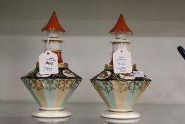 A pair of continental porcelain perfume bottles painted with birds and insects.