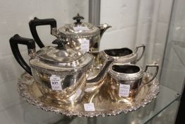 A four piece tea service and a plated tray.