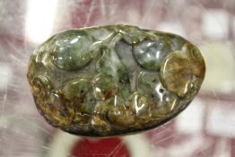 A Chinese carved jadeite pebble.