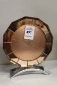 An Art Deco pink glass mantle clock.