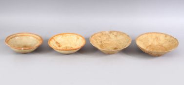 A LOT OF FOUR EARLY CHINESE POTTERY BOWLS, some glazed some unglazed. largest: 18cm diameter