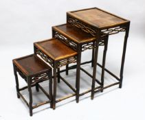 A GOOD 19TH CENTURY CHINESE HARDWOOD NEST OF FOUR TABLES, graduating sizes, with pierced frieze,