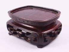 A FINE 18TH / 19TH CENTURY CHINESE CARVED HARDWOOD STAND, with a carved frieze and greek key border,