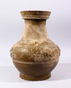 A GOOD CHINESE HAN DYNASTY TWIN HANDLE VASE, the vase with naturalistic remains, twin archaic handle