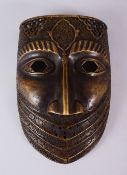 A GOOD 19TH / 20TH CENTURY PERSIAN BRONZE CALLIGRAPHIC MASK, with carved panels of calligraphy and
