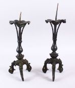 A PAIR OF CHINESE MING BRONZE ALTER / CANDLE STICKS, with lotus form base, on three lion dog moulded