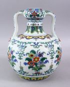 A CHINESE DOUCAI PORCELAIN TWIN HANDLE VASE, the body decorated with sprays of flora, twin moulded