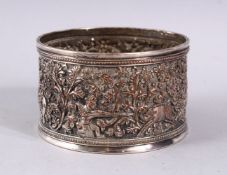 A GOOD ELKINGTON INDIAN SCENE SILVERED BOTTLE COASTER, with hunting scenes and floral decoration,