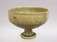 AN EARLY ISLAMIC POSS MAMLUK GREEN CELADON FOOTED POTTERY BOWL. 15cm
