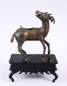 A GOOD CHINESE BRONZE CENSOR OF A DEER, stood upon a fixed carved wooden base, the deer with its