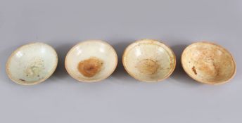 A LOT OF FOUR EARLY CHINESE POTTERY BOWLS, some glazed some unglazed. largest 15.5cm diameter.
