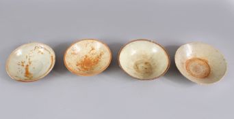 A LOT OF FOUR EARLY CHINESE POTTERY BOWLS, some glazed some unglazed. largest 16cm diameter.