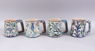 A COLLECTION FOUR EARLY 20TH CENTURY IZNIK STYLE JERUSALEM PALESTINIAN POTTERY TANKARDS, with