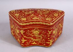 A CHINESE MING STYLE RED GROUND DRAGON PORCELAIN LIDDED BOX, with dragons and clouds, the base