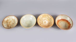 A LOT OF FOUR EARLY CHINESE POTTERY BOWLS, some glazed some unglazed. largest 16cm diameter.